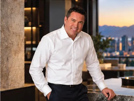 Chris Lotoski seated by a window overlooking the city